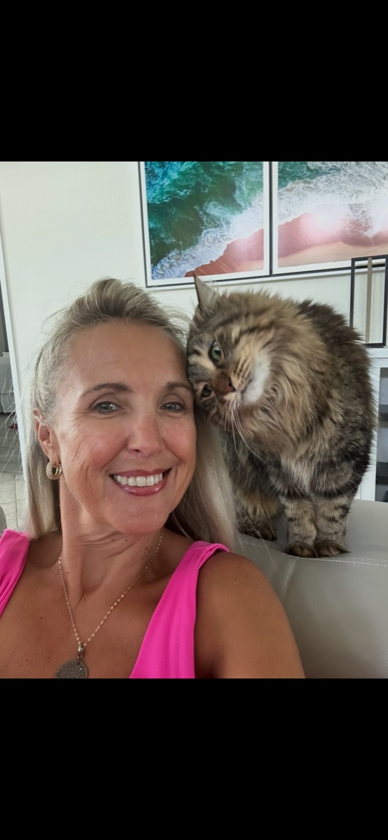 Lisa sharing a quiet moment with a fluffy tabby cat