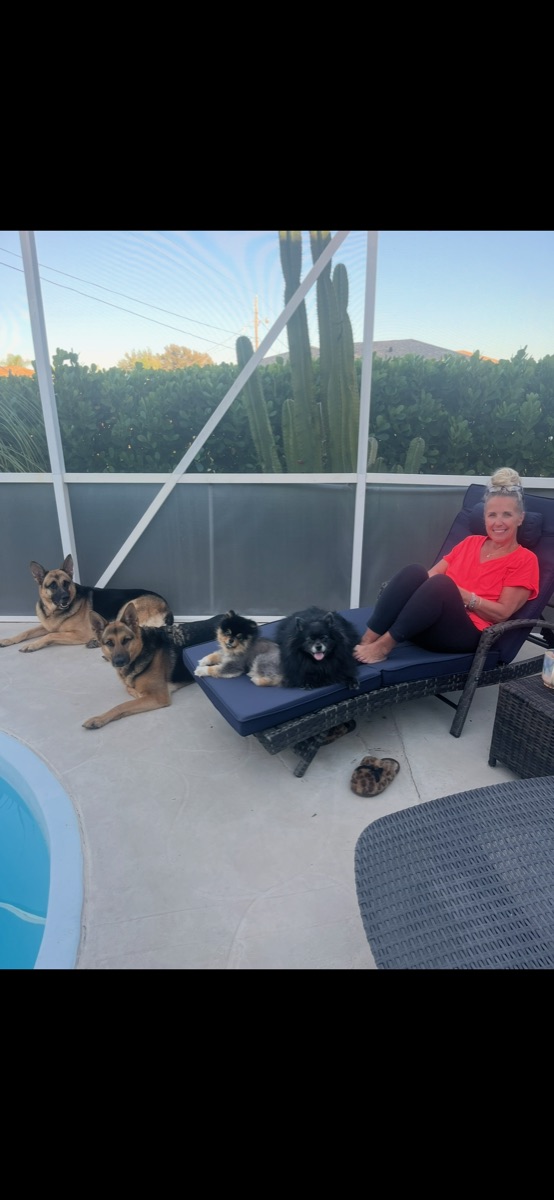 Lisa relaxing with a group of dogs